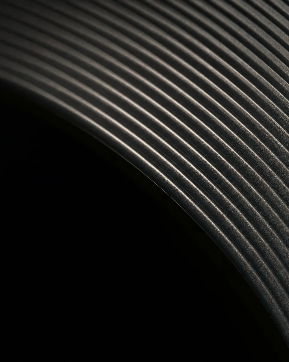 A machined metal mechanism in close crop, lit from one side.