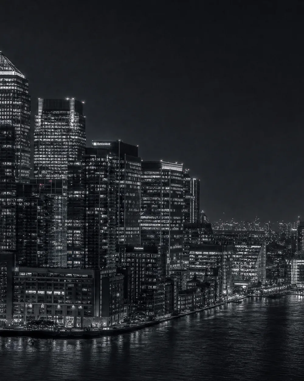 A city at night from the air, traffic drawn out into lines of light.