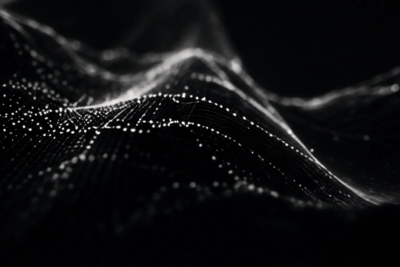 A field of light points describing a curved surface in the dark.
